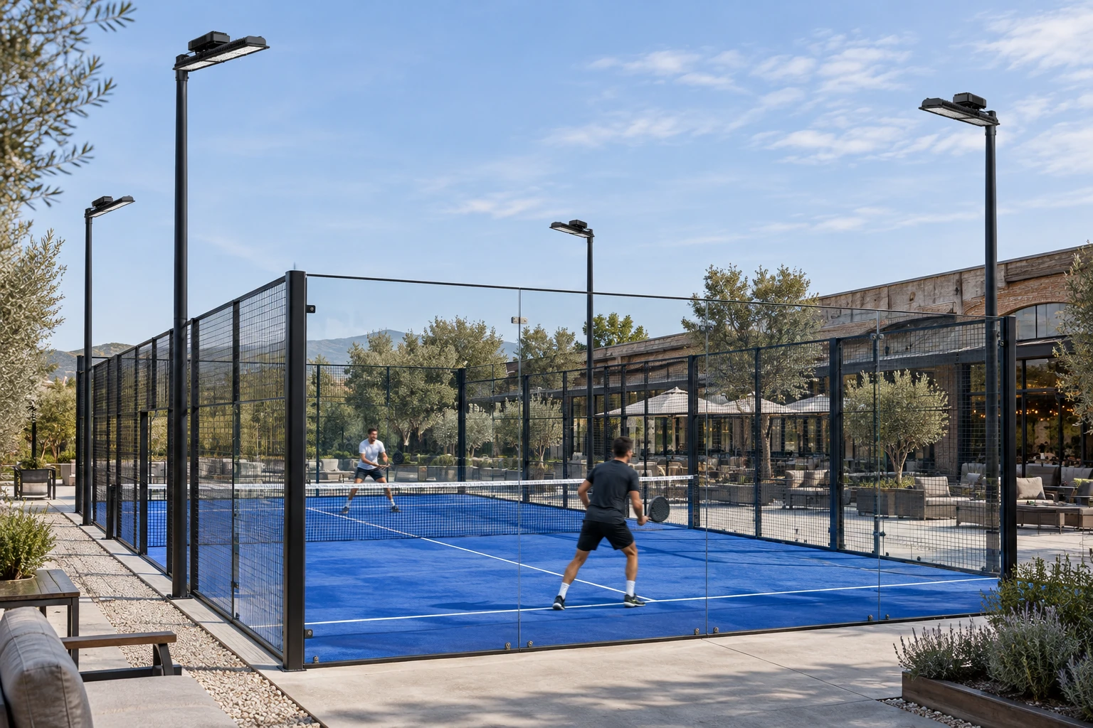 Daytime concept with switched-off PADEL PRO luminaires on poles outside the court, a black 914 × 145 × 148 mm linear housing, heat sink and driver compartment. It identifies no power or optic and does not represent measured lighting performance.